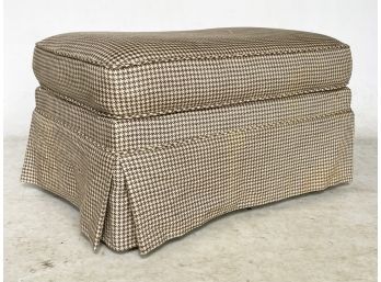 An Upholstered Ottoman In Houndstooth Print