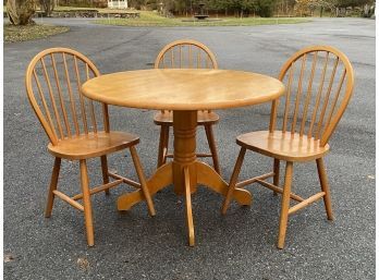 An Oak Dining Table With A Set Of 3 Windsor Chairs