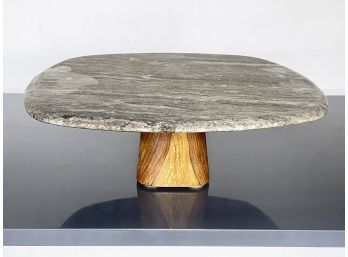 A Modern Granite Cake Platter With Exotic Hardwood Base