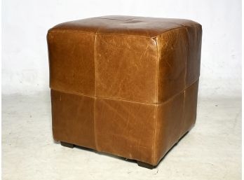 A Tawny Leather Ottoman By Mitchell Gold