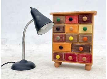 A Vintage Style Desk Lamp And Colorful Notions Drawer Unit