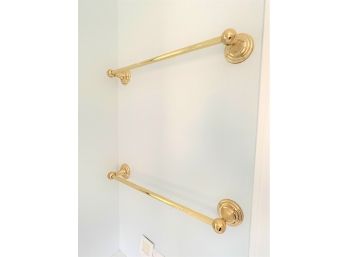 A Set Of Four Gold Tone Towel Bars