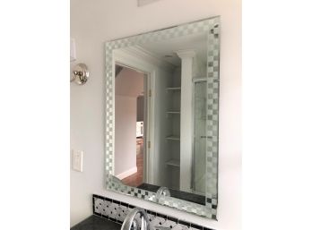 A Vanity Mirror With Checkerboard Edge