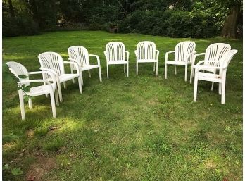 Eight White Resin Chairs