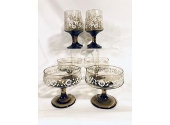 Set Of Eight Mid-century Modern Smoked Glass Footed Tumblers And Champagne Glasses With Daisy Pattern