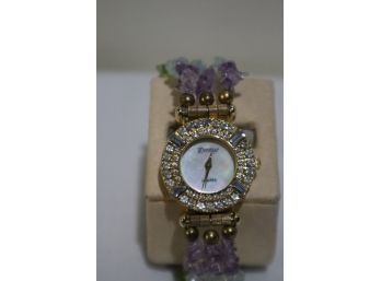 Prestige Quartz Watch With Mother Of Pearl Face, Rhinestones, Gold Tone Clasp And Band Has Colored Stones