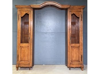 A Paneled Wood Armoire With Center Arbor