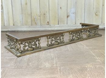 An Antique Brass Fireplace Fender