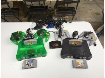 Pair Of Nintendo 64 Consoles With Controllers And PS2 Controllers.