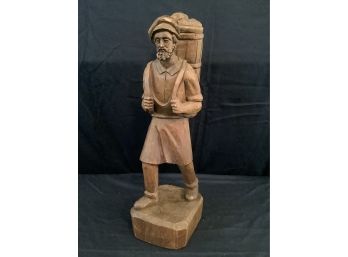 Wood Carved Statue Of A Man Carrying A Bucket