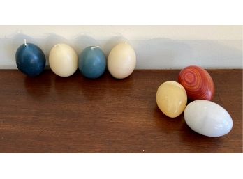 Four Wax Egg Form Candles, Two Polished Stone And One Polished Wood Egg