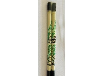 A Set Of Chop Sticks With A Panda Painted On