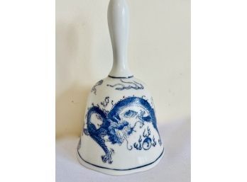 White And Blue Porcelain Bell With A Dragon On It