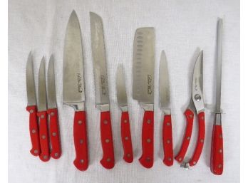 A Grouping Of Pioneer Woman Cutlery Pieces With Red Handles