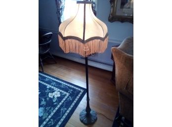 Tall Victorian Style Metal Lamp With Silky Shade That Has Brocade And Tassles