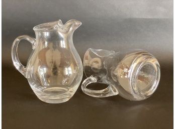 A Pair Of Compatible Clear Glass Pitchers