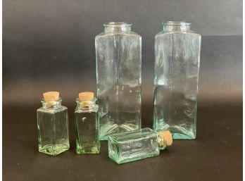 A Grouping Of Contemporary Green Glass Bottles, Some With Stoppers