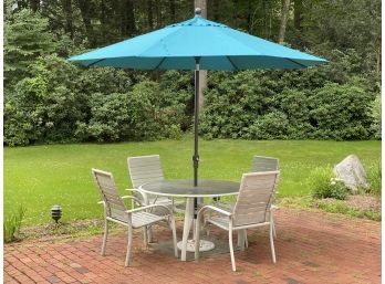 An Outdoor Dining Set & Sunbrella Umbrella