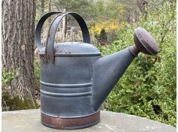 A Copper And Steel Watering Can