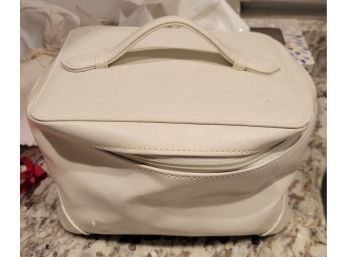 Donna Karan White Leather Cosmetic Bag Filled With Jewelry.            Loc: Cabinet Next To Back Door