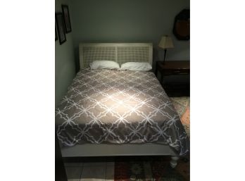 Queen Sized Bed With White Caned Back Headboard