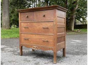 A 19th Century Paneled Oak Serpentine Front Dresser