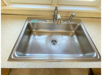 A Stainless Steel Sink With Moen Hardware