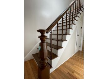 A Wood Stair Railing And Newel Post
