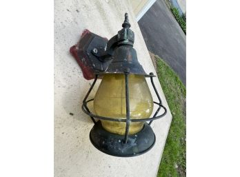 A Vintage Metal Sconce With Yellow Globe