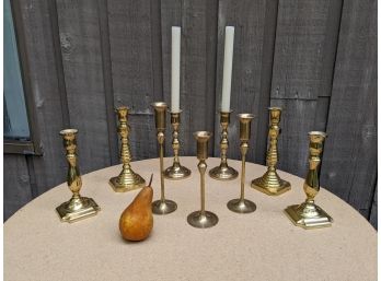 A Grouping Of 9 Brass Candle Holders