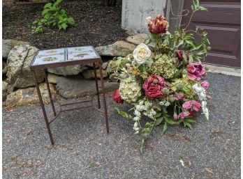 Faux Flower Arrangement In Portuguese Pot And Tile Top Iron Table