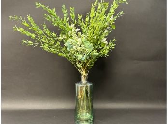 Quality Faux Florals In A Clear Green Glass Bottle