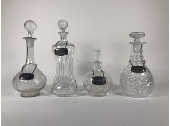 Four Glass Decanters With Tags