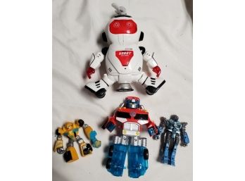 White Toy Robot & Three Transformer Style Robots That Convert Into Vehicles  E3