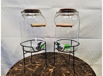 Two One Gallon Glass Beverage Dispensers With Metal Stand And Handle