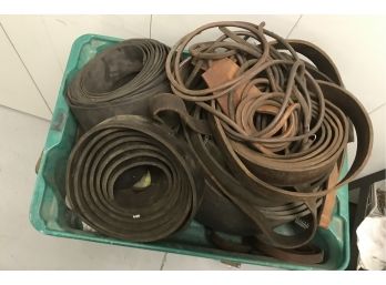 Assortment Of Leather Belts With Green Fiberglass Container