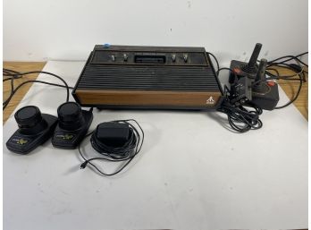 VINTAGE ATARI VIDEO COMPUTER SYSTEM MODEL CX-2600A W/ TWO JOYSTICKS AND TWO PADDLE CONTROLLERS, ALL WIRES INC.