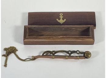 A VINTAGE COPPER AND BRASS NAVAL WHISTLE IN A BRASS INLAID TEAKWOOD BOX