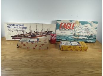 FOUR VINTAGE BOAT MODELS UNASSEMBLED IN BOXES, THREE ARE WOOD MODELS