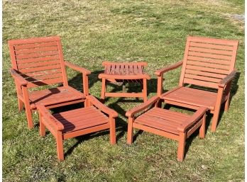 A Set Of Painted Teak Lounge Chairs And A Cocktail Table