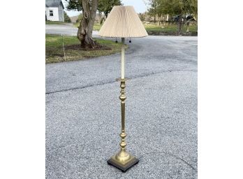 A Large Standing Lamp With Brass Base