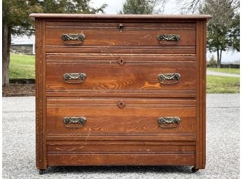 An Antique Paneled Oak Chest Of Drawers