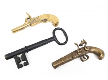 Two Brass Pistol Figures And An Iron Key