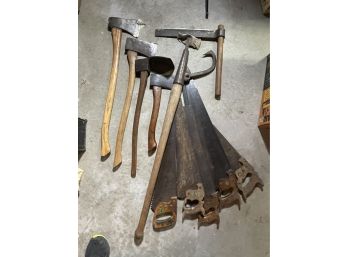 LOT OF SAWS , HATCHETS AND OTHER TOOLS