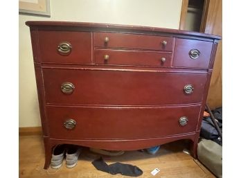 A RED PAINTED OVAL MIRROR AND BOW FRONT CHEST