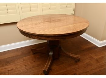 Antique Tiger Oak Round Pedestal Table On Casters With One Leaf