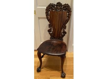 Ornate Carved Chair With Plant Decor On Back