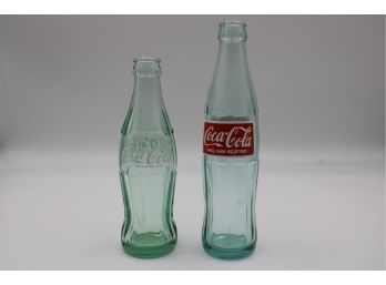 (2) VINTAGE COCA-COLA BOTTLES W/ ARABIC PRINT ON LABEL