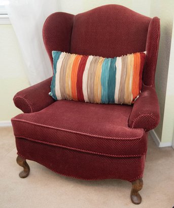 Red Armchair With Rainbow Throw Pillow