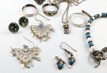 A Group Of Jewelry With Sterling Silver  Rings, Earrings, Bracelet, And Necklace.